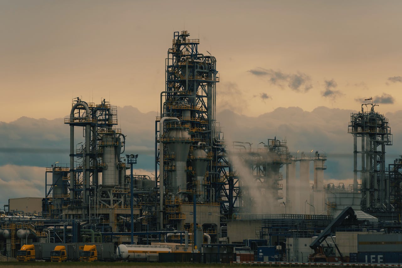 Industrial plant with smokestacks against a cloudy sky